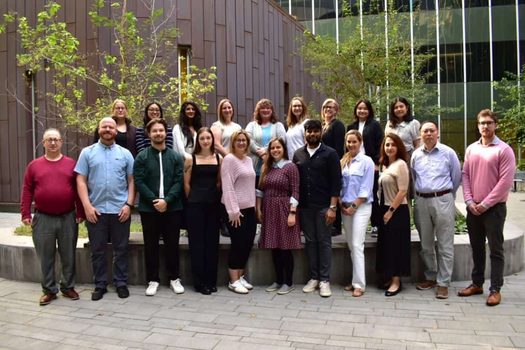 Collaborative research for a healthier tomorrow. 1 Group photo of several people standing outside.