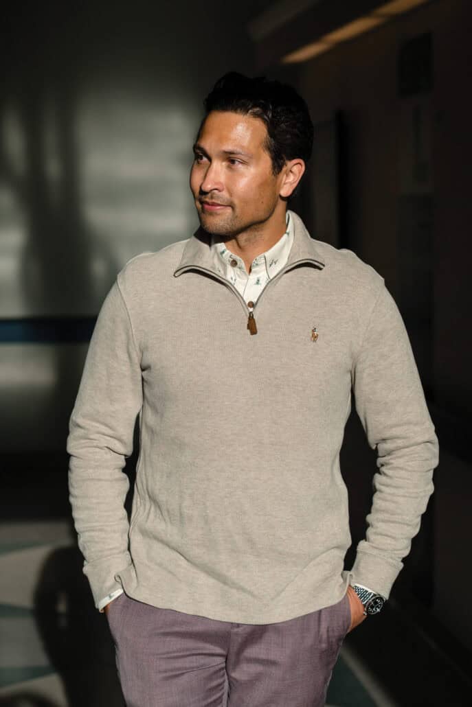 Allan Black stands looking to the side with his hands in his pockets.