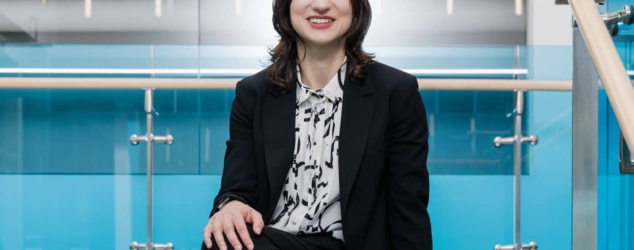 Dr. Ana Nikolic sits with her hand on her knee.