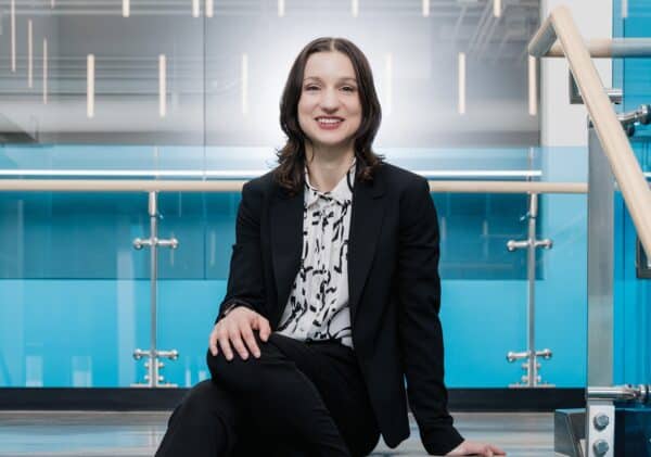 Dr. Ana Nikolic sits with her hand on her knee.