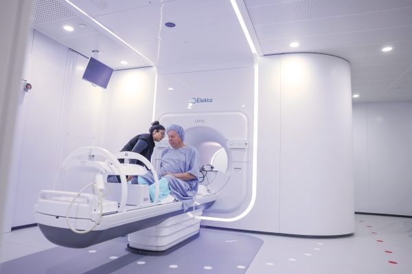Barry Flavelle in a hospital gown entering an MR-Linac machine.
