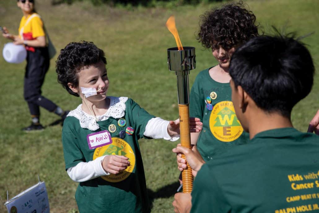 Kids at camp looking at a torch.
