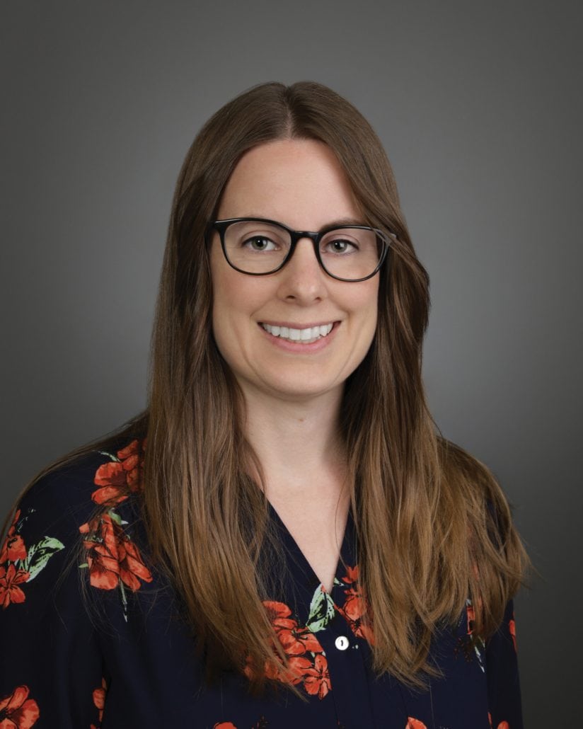 Next generation research. 1 Portrait of a woman in a flower shirt smiling at the camera.