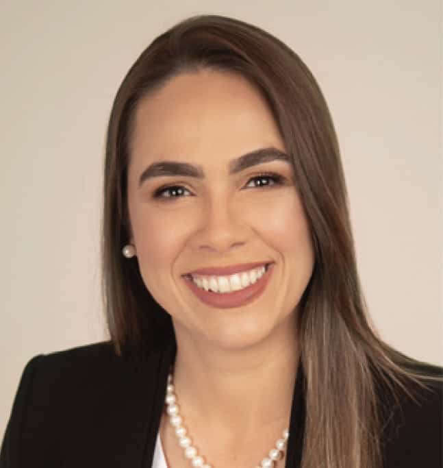 Headshot of Dr. Carla Prado wearing a black blazer and a pearl necklace.