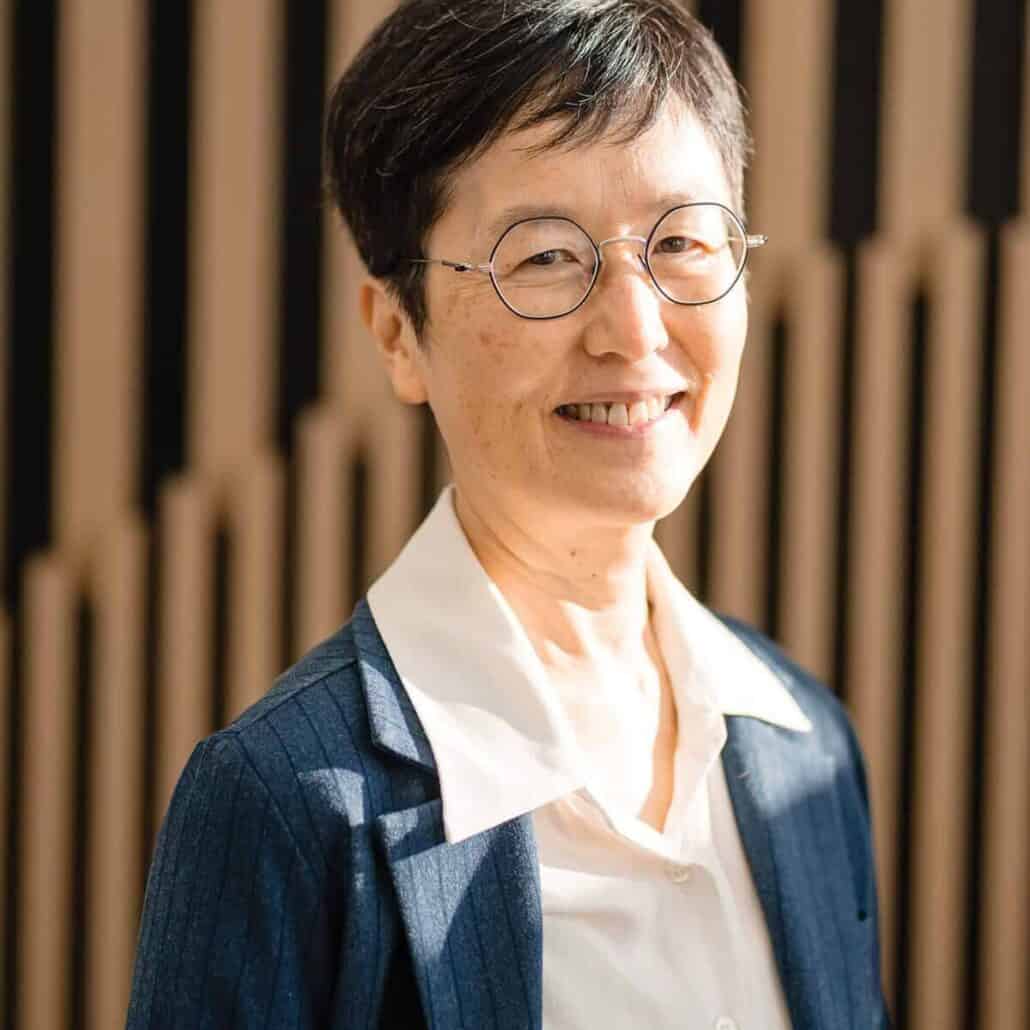 Portrait of a woman with short hair and glasses.