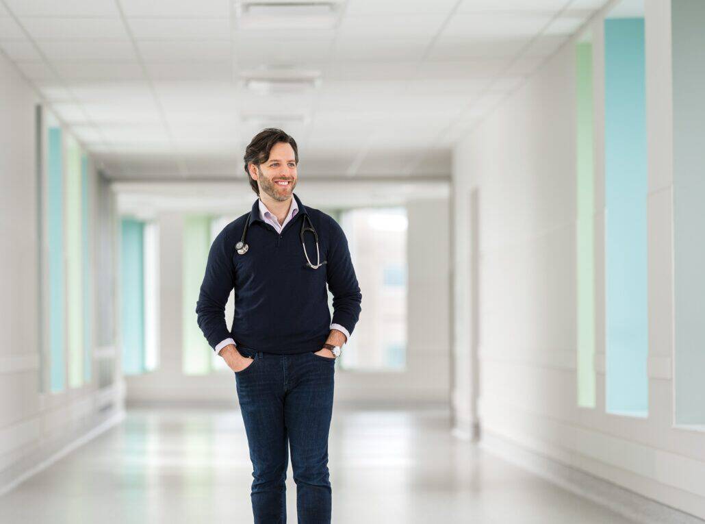 Dr. Jordan Zeppieri walking down a hospital hallway. 