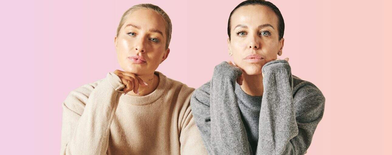 Helping women reclaim their bodies. 2 Two women pose looking into the camera with a pink background.