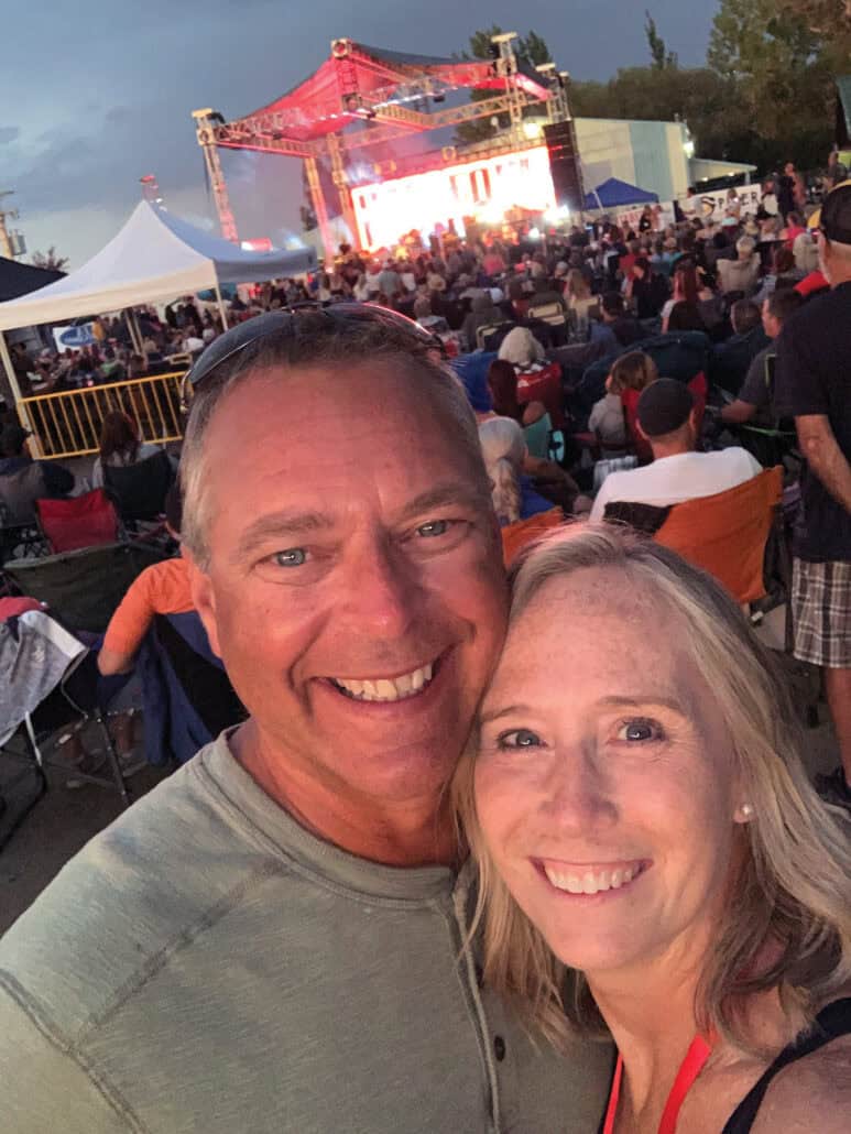 A selfie of a man and woman at a concert.