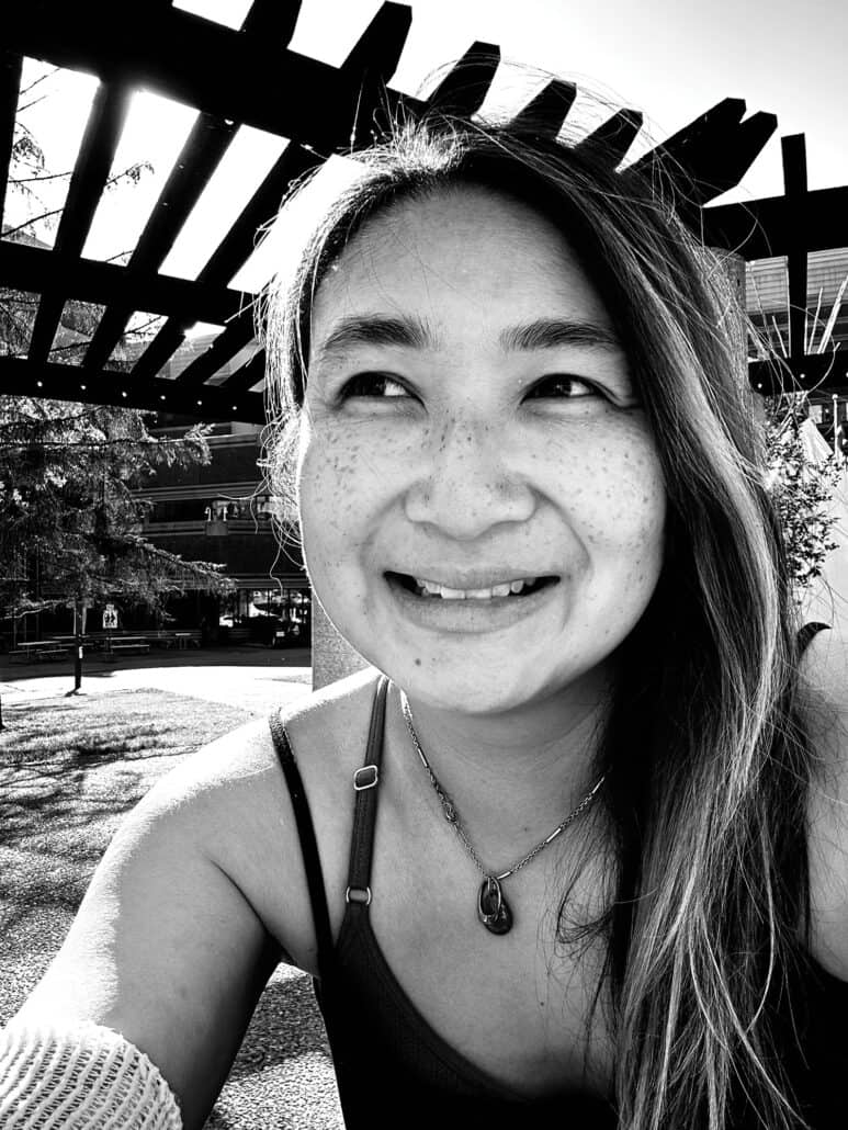 A black and white selfie of a woman.