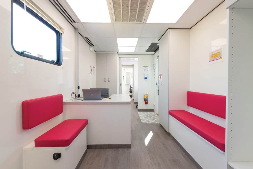 True calling. 5 The interior of the unit with pink seating and clean, white walls and surfaces.
