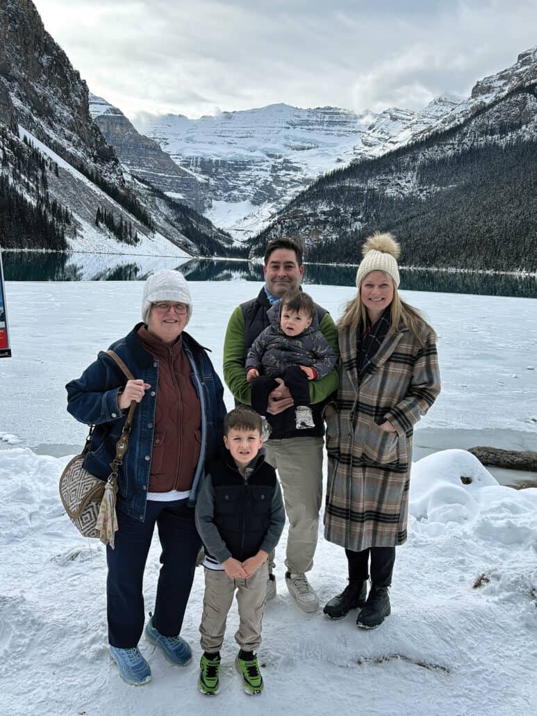 Family picture in front of Lake Louise in the winter.