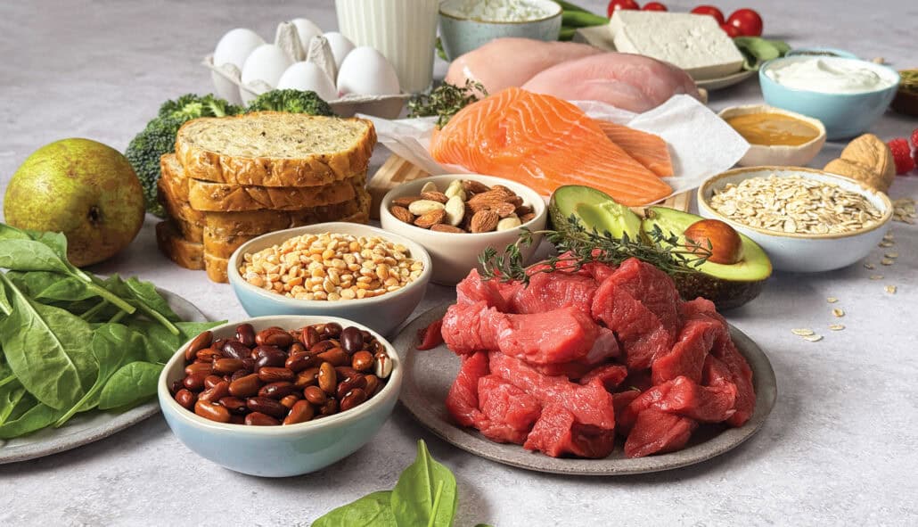 A medley of healthy foods, including raw beef, salmon, avocado, multigrain bread, nuts, eggs, oats and tofu. 