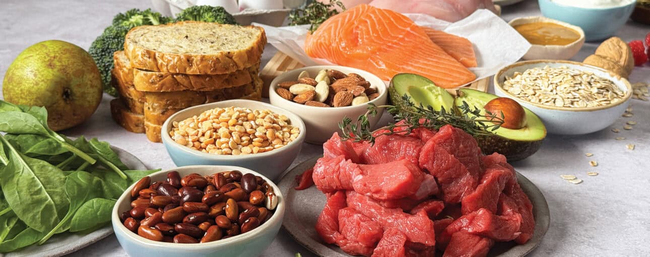 A medley of healthy foods, including raw beef, salmon, avocado, multigrain bread, nuts, eggs, oats and tofu.