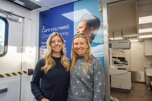 Sarah Parkin, philanthropy officer at the Alberta Cancer Foundation and Sky Mitchell, CEO of Basecamp Resorts, tour the Mobile Breast Screening Unit in Canmore.