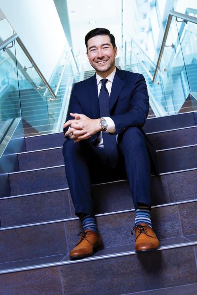 Leading the way. 6 Man in blue suit sitting on stairs.